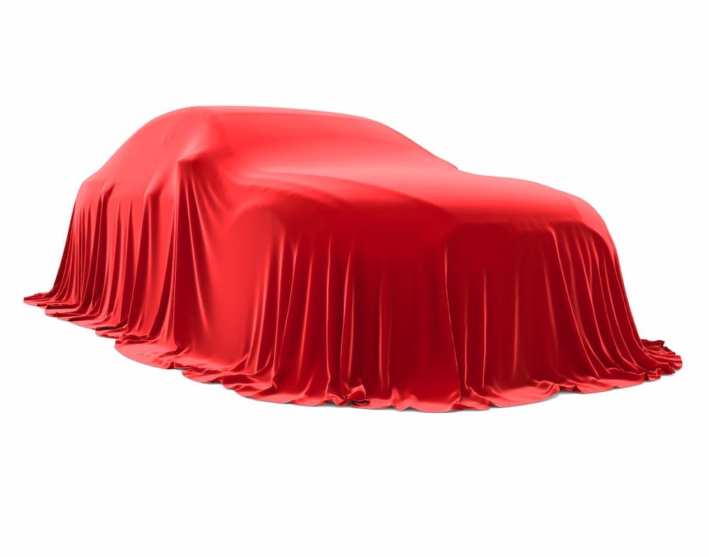 A vehicle draped in a red sheet